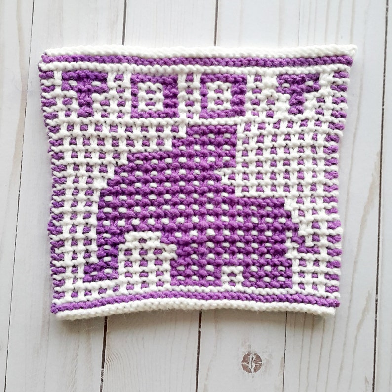 Puede incluir: Un pa&ntilde;o de cocina de punto morado y blanco con un patr&oacute;n geom&eacute;trico.
