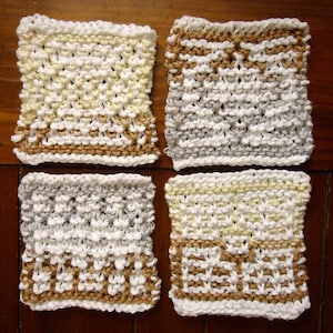 May include: Four knitted dishcloths in different color combinations. The dishcloths are white with brown, beige, and light yellow accents. The dishcloths are square and have a textured knit pattern.