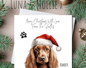 May include: A Christmas card featuring a Cocker Spaniel wearing a Santa hat. The card reads "Merry Christmas With Love From The Smiths" and includes a paw print. The dog's name, "Amber," is printed below the image.
