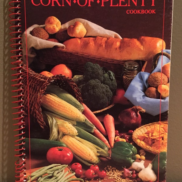 Vintage 1986 “Corn of Plenty” Cookbook by Laurie Woody and Pioneer Hi-Bred International, Inc.. Paperback with spiral binding and 96 pages o