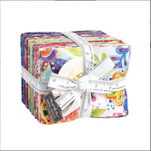 May include: A stack of colourful fabric squares with a white background and floral patterns. The fabric is tied together with a white ribbon and a measuring tape that reads "moda fabrics".