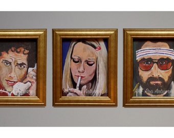 May include: Three framed paintings of pop culture icons. The first painting is of a man on the phone, the second is of a woman smoking a cigarette, and the third is of a man wearing a headband and sunglasses.