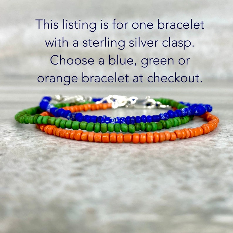 May include: Three beaded bracelets in blue, green, and orange with a sterling silver clasp.  "This listing is for one bracelet with a sterling silver clasp. Choose a blue, green or orange bracelet at checkout."