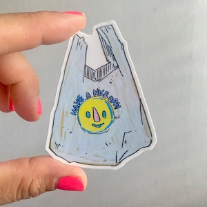May include: A blue and white plastic bag sticker with a yellow smiley face and the text "Have a Nice Day".