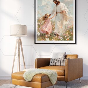 May include: Framed art print depicting a figure in white robes holding the hand of a young girl in a pink dress. The artwork is set in a field of flowers with a blue sky background. The print is displayed above a brown leather chair and ottoman.
