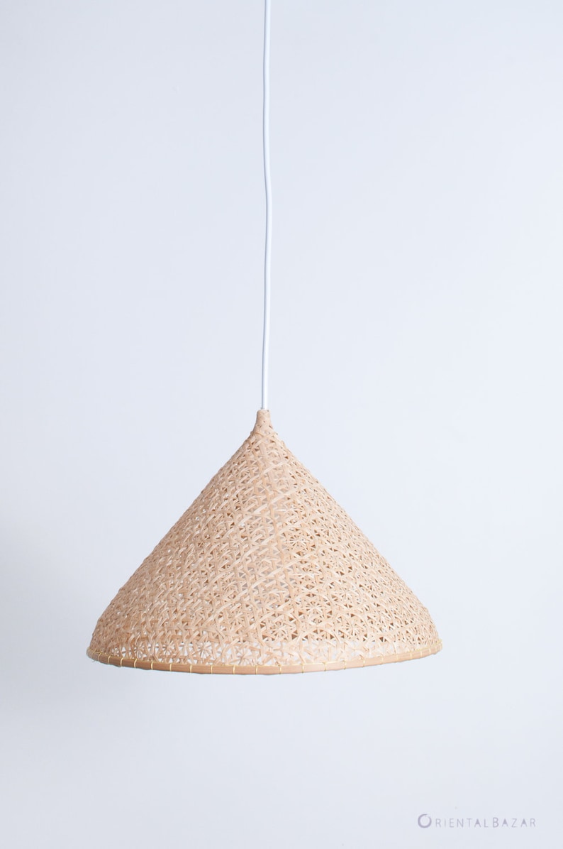 May include: A woven, cone-shaped pendant light fixture hangs from a white cord against a white background.
