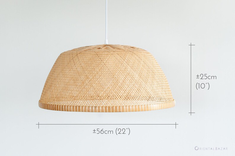 May include: A woven bamboo pendant light fixture with a white cord. The light fixture is 22 inches wide and 10 inches tall.