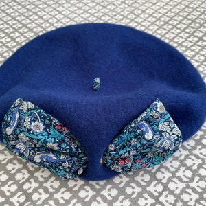 A royal blue wool beret, with a Libery Print Fabric bow