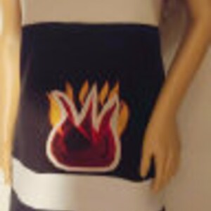 May include: A black and white striped dress with a pink "FIRE BALL" logo and a red and orange flame graphic. The dress has a white stripe at the bottom with the text "THE ORIGINAL" and "ALCOHOL 12%".