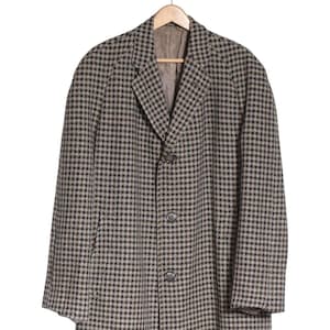 May include: A brown and tan checkered overcoat with a single-breasted closure and three buttons.