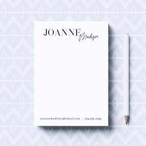 May include: White notepad with a blue geometric pattern background. The notepad has a blue header with the text "JOANNE Madison" and the contact information "joannemadison@email.com - 234-555-2345" at the bottom.