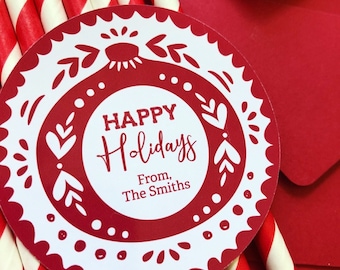 May include: A festive image with red and white striped straws, a red envelope, and a circular tag. The tag has a decorative border and the words "HAPPY Holidays From, The Smiths" in red.