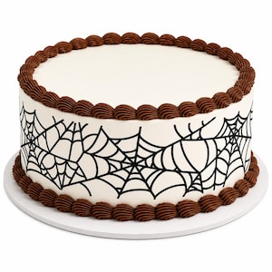 May include: A round cake with smooth white frosting, decorated with black spider web patterns around the sides. The top and bottom edges are finished with a decorative border of piped brown frosting swirls on a white circular cake board.