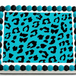 May include: A rectangular cake with a turquoise leopard print design. The cake is decorated with alternating black and turquoise frosting swirls around the edges.