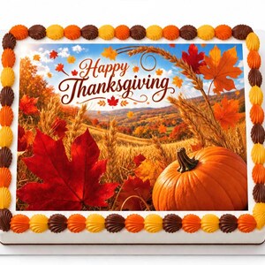 May include: A square sheet cake featuring an edible image of a fall landscape with a large orange pumpkin, golden wheat stalks, and vibrant red and orange maple leaves. The text Happy Thanksgiving is printed in brown script on the cake surface.