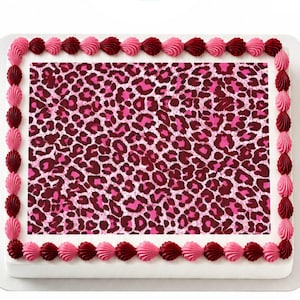 May include: A rectangular cake with a pink and burgundy leopard print design. The cake is decorated with a border of pink and burgundy frosting in a shell pattern.