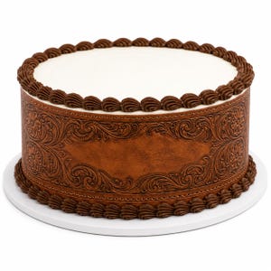 May include: A round cake with a smooth white top surface and a brown side panel featuring an embossed floral and scroll pattern. The top and bottom edges of the cake are decorated with a continuous border of dark brown piped frosting swirls.