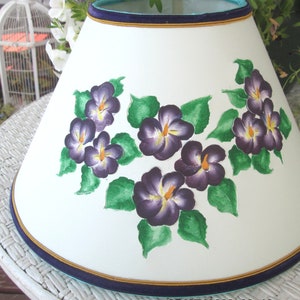 Cut and pierced paper lampshade,hand-painted purple violets, green leaves, round clip-on.5X12X6.75". White paper turns pretty teal when lit!
