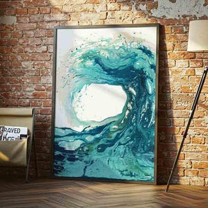 May include: A rectangular framed wall art print featuring an abstract fluid painting of a large ocean wave in shades of teal, turquoise, and deep blue. The artwork displays swirling water patterns with white highlights, set against a white background.
