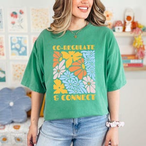 May include: A green t-shirt with a floral design and the text "CO-REGULATE & CONNECT" printed on the front.