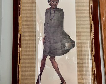 May include: A framed print featuring a watercolor illustration of a person with short dark hair wearing a loose grey garment and a thin necklace. The artwork is titled "Young Maasai Warrior" and signed by the artist, set within a brown wooden frame.