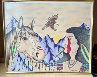May include: Framed artwork depicting a Native American person and a horse, set against a mountain backdrop with an eagle soaring above. The artwork features vibrant colors and detailed illustrations, with a gold frame.