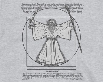 Puede incluir: Una camiseta gris con una ilustración en blanco y negro de un hombre con una túnica con los brazos extendidos, rodeado de un círculo y un cuadrado. El texto "You shall not pass" está debajo de la ilustración. El texto sobre la ilustración es una cita de "El Señor de los Anillos".