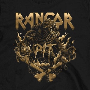 May include: Black t-shirt featuring a gold graphic design with the word "RANGAR" above a monster illustration and the word "PIT". The design includes flames, bones, and chains. The website address "www.paulsimic.com" is at the bottom.