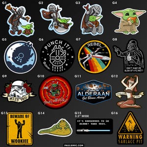 May include: A collection of sixteen Star Wars themed vinyl stickers featuring various characters and icons including a Mandalorian, Grogu, Darth Vader, a Stormtrooper, Boba Fett, Jabba the Hutt, and text-based designs like Beware of Wookiee.