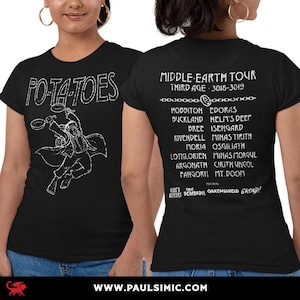 May include: Black t-shirt featuring a white graphic of a character holding cooking pans with the word "POTATOES" above. The back of the shirt lists a "MIDDLE-EARTH TOUR" with locations and dates. Website address at the bottom.