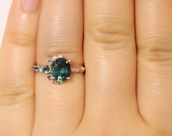 2 carat Oval Teal Blue Green Sapphire Engagement Ring with Half Moon Ombre Cluster Halo