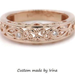 May include: A delicate rose gold band with a filigree design and small diamonds set in the band.