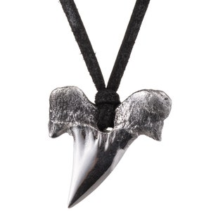 Back image of poured silver shark's tooth pendant and deerskin leather necklace.