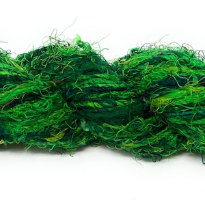 May include: A vibrant skein of green yarn, with varying shades of emerald and lime, creating a textured, handmade appearance. The yarn appears to be made of multiple strands, perfect for knitting or other fiber crafts.