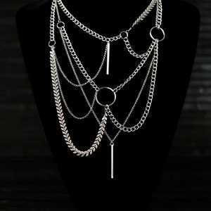 Multi-layered Myril Jewels necklace, cascading chains with central o-ring. Ideal for gothic-chic, Witchcore enthusiasts or as a bold statement piece at rave parties.