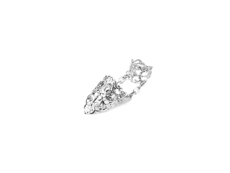 May include: A silver filigree ring with a pointed design and a chain connecting to a second ring. The ring is designed to be worn on two fingers.