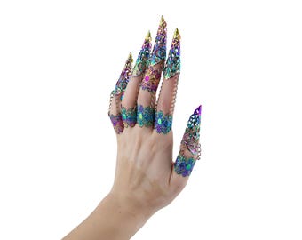 May include: Iridescent finger armor with intricate filigree and chain details. The claw-like design features a spectrum of colors, including gold, purple, and teal. This unique accessory adds a touch of fantasy to any look.