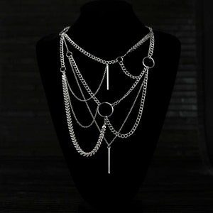 A multi-layered Myril Jewels necklace, featuring mixed chains and central o-rings, embodies neo-gothic elegance.