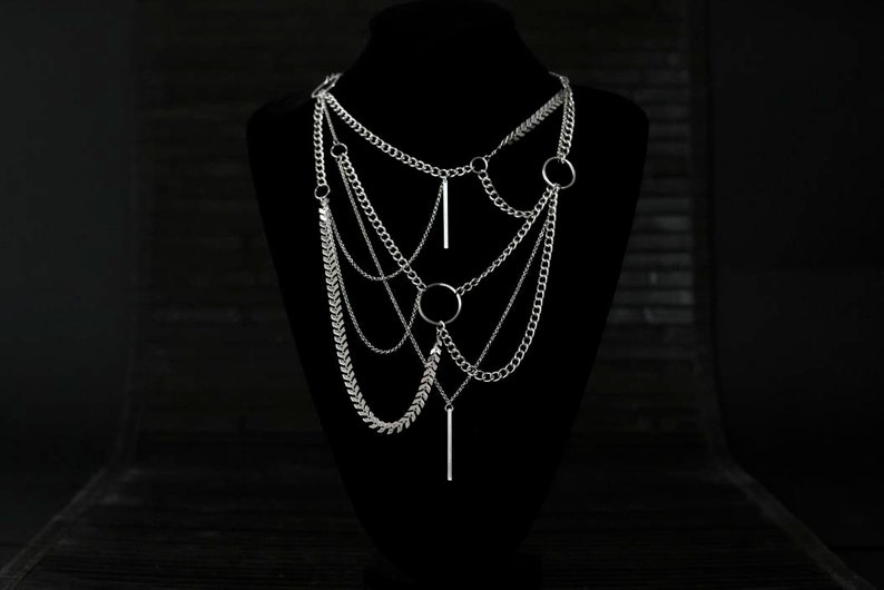 A multi-layered Myril Jewels necklace, featuring mixed chains and central o-rings, embodies neo-gothic elegance.