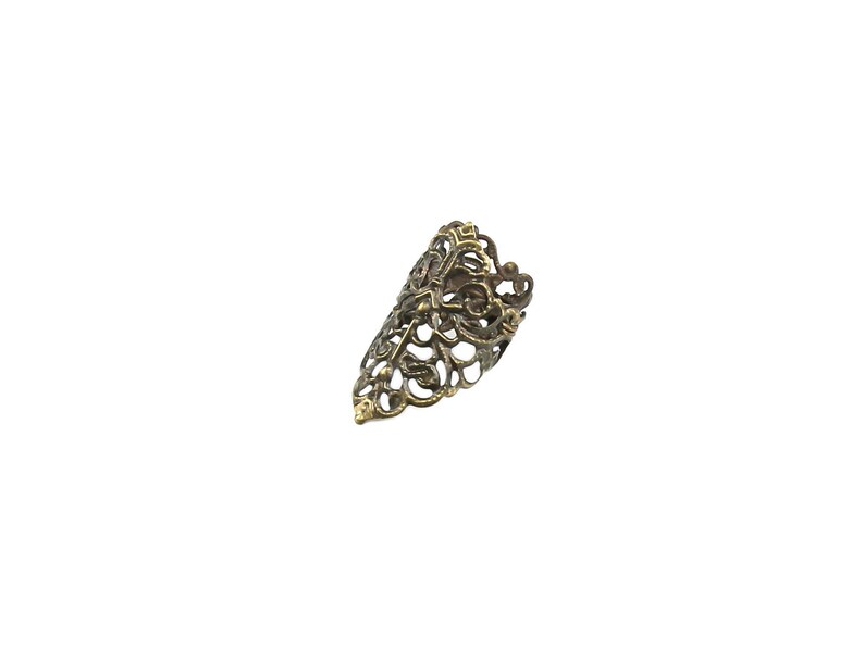 May include: A gold-toned filigree ring with a delicate, intricate design. The ring is open and adjustable to fit most finger sizes.