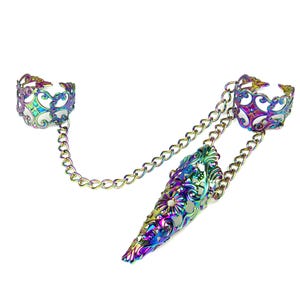 May include: A multi-colored, iridescent finger armor ring set. The set includes two rings connected by a chain, with an ornate, floral design. The finger armor ring is a pointed shape, and the rings are connected by a chain.