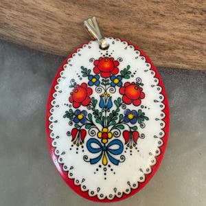 Floral oval enamel pendant charm for a necklace.