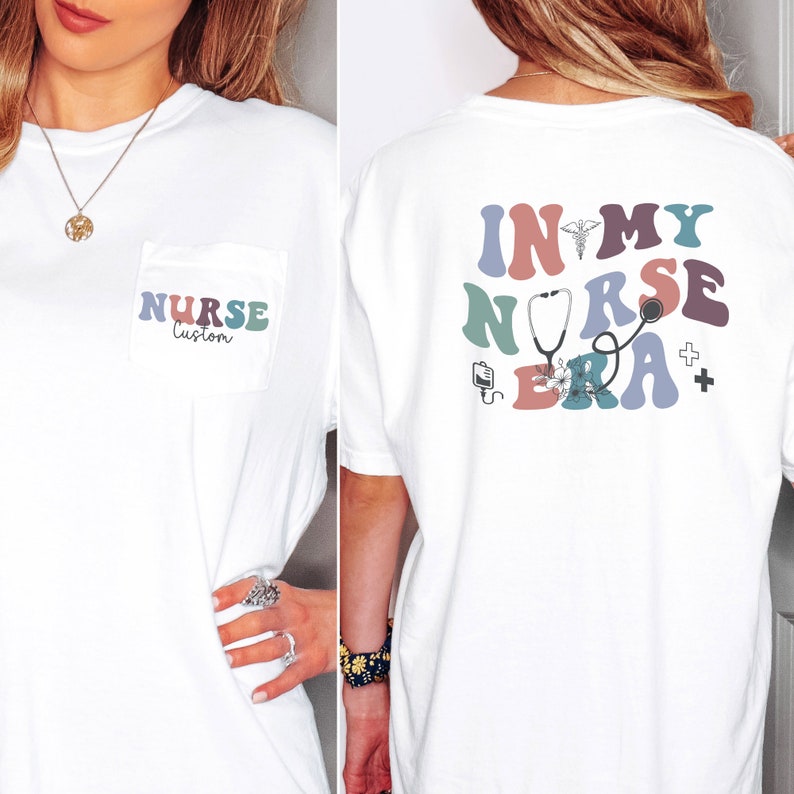 May include: White t-shirt with a pocket on the front and a graphic on the back. The pocket has the text "NURSE Custom" in colorful letters. The back graphic says "In My Nurse Era" in colorful letters with medical symbols.
