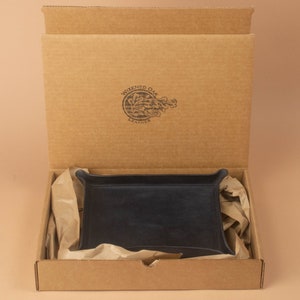 The tray packaged in a simple brown cardboard box, nestled in brown packing paper. The box opens from the top and displays the Wizened Oak Leather logo on the inside of the lid.