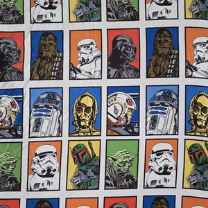 May include: A white fabric featuring a repeating pattern of Star Wars characters in colorful rectangular frames. Characters include Stormtroopers, Darth Vader, Yoda, Chewbacca, Boba Fett, C-3PO, and R2-D2.