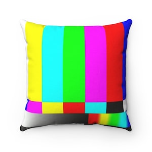 May include: A square throw pillow with a colorful television static pattern. The pattern features vertical stripes of yellow, cyan, green, magenta, and red. The bottom of the pillow has a small rainbow pattern.