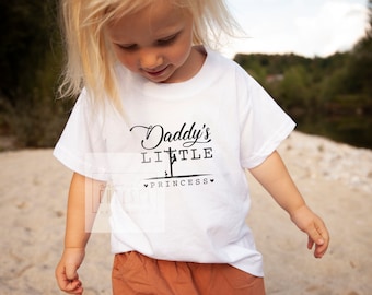 May include: A white t-shirt with black text that reads "Daddy's Little Princess" with a small graphic of a power line pole.