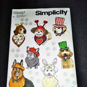 May include: Simplicity sewing pattern S9497 featuring dog costumes. The cover art shows illustrated dogs dressed in various outfits, including a reindeer, heart-themed attire, a patriotic hat, a leprechaun hat, a pumpkin, and bunny ears.