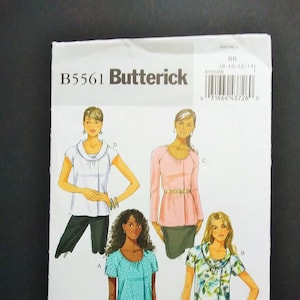 May include: A Butterick sewing pattern envelope featuring illustrations of four different blouse designs. The envelope is white with the text "B5561 Butterick" in black. The illustrations show blouses in various colors and patterns, including a polka dot and floral print.