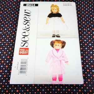May include: A sewing pattern titled "see & sew" B5414, featuring two doll designs. One doll wears a black top and white skirt, the other a pink robe and pants. The pattern includes the text "YES! it's EASY".